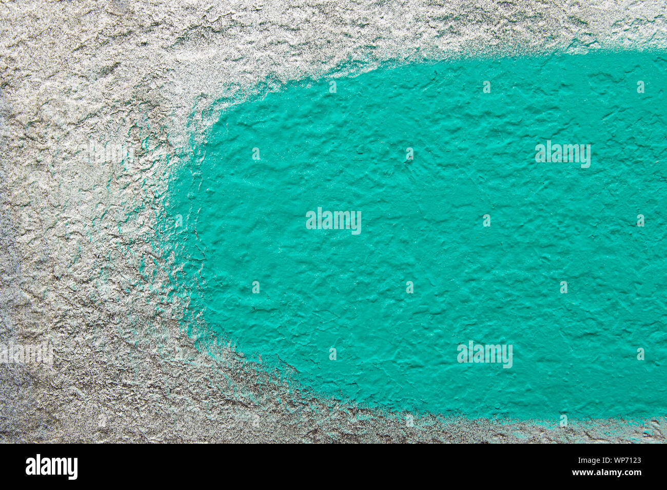 Green stripe with a brush on a gray wall - background texture Stock Photo