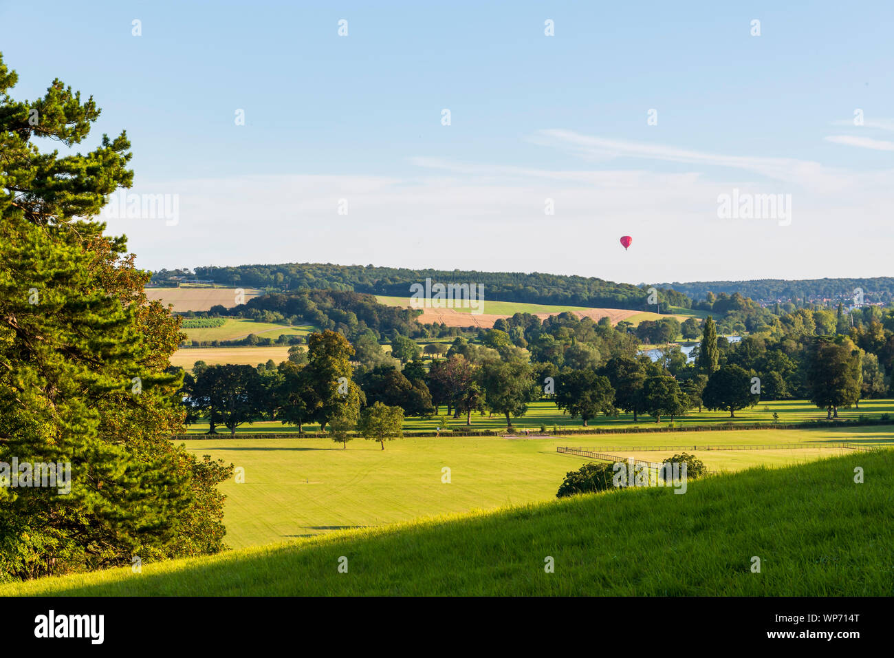 A hot air balloon rises above the Thames in the Chilterns Stock Photo