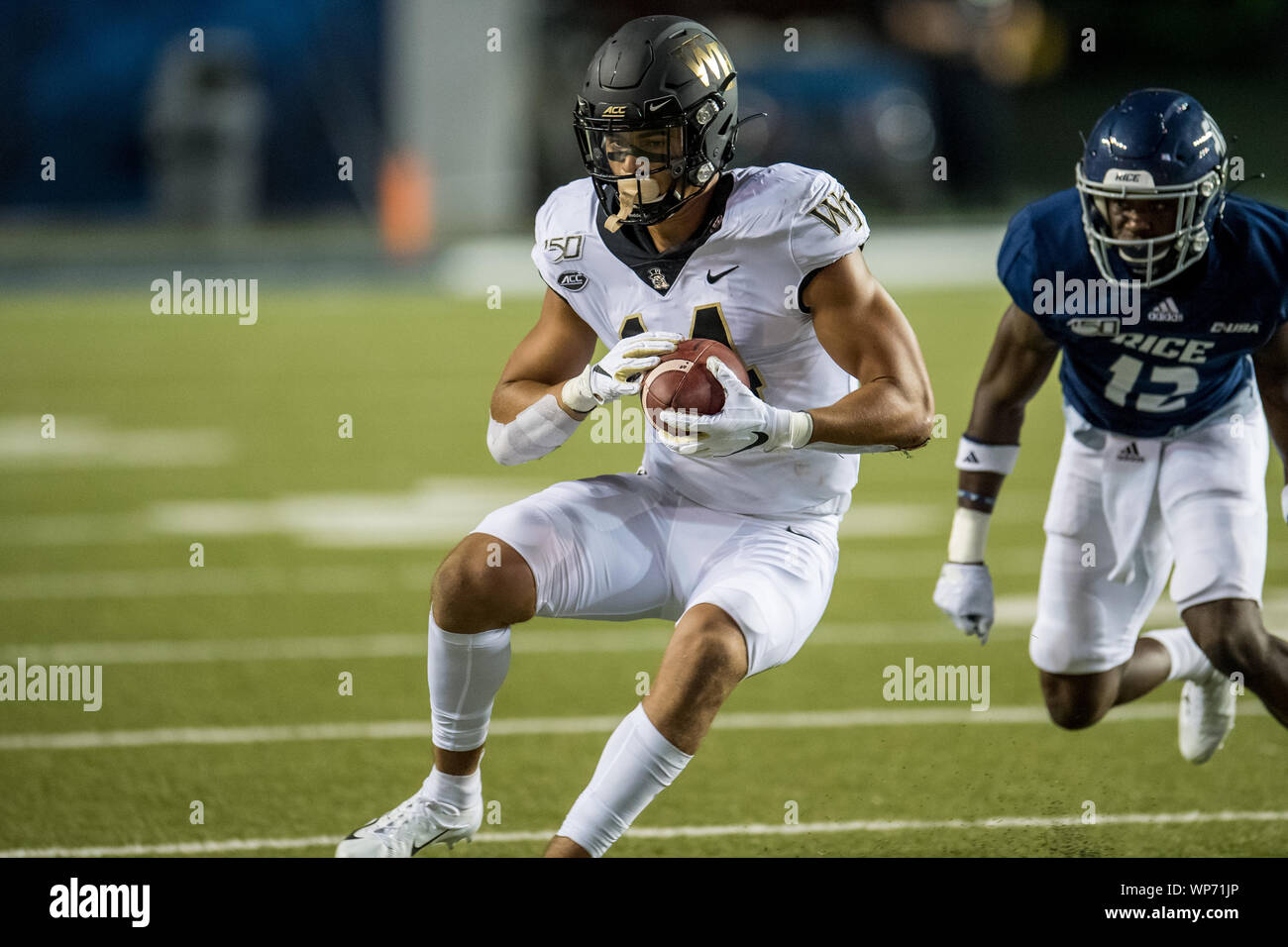 Houston, TX, USA. 6th Sep, 2019. Wake Forest Demon Deacons wide receiver Sage Surratt (14) makes a catch in front of Rice Owls defensive back D'Angelo Ellis (12) during the 1st quarter of an NCAA football game between the Wake Forest Demon Deacons and the Rice Owls at Rice Stadium in Houston, TX. Wake Forest won the game 41 to 21.Trask Smith/CSM/Alamy Live News Stock Photo