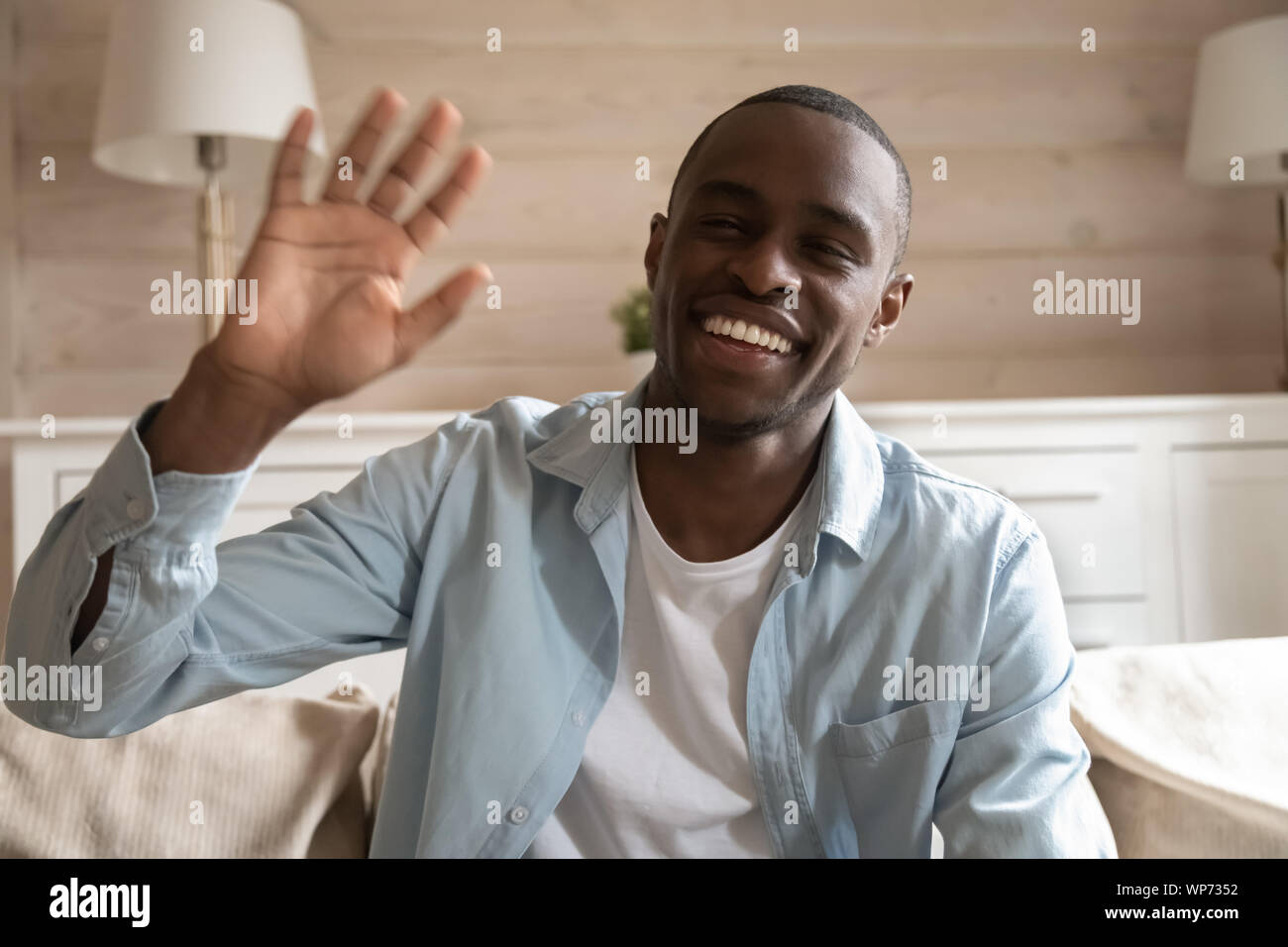 Smiling african American man wave having video call Stock Photo