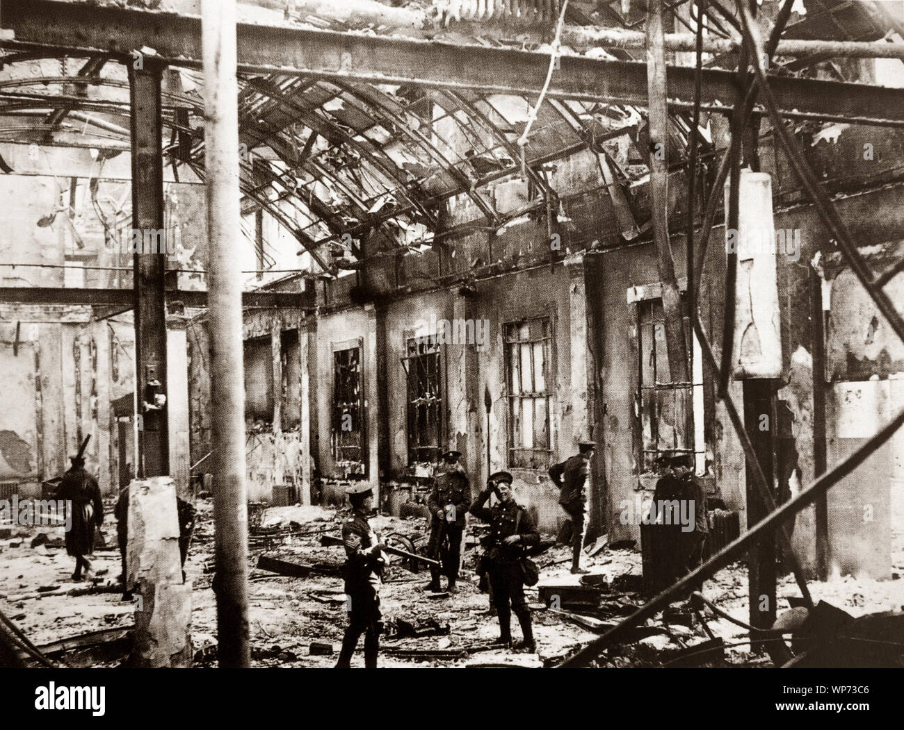 British soldiers standing in the badly damaged General Post Office (GPO) in Sackville Street (now O'Connell  Street) Dublin. During the Easter Rising of 1916, the GPO served as the headquarters of the uprising's leaders. It was from outside this building on the 24th of April 1916, that Patrick Pearse read out the Proclamation of the Irish Republic. The building was destroyed by fire in the course of the rebellion, save for the granite facade, and not rebuilt until 1929, by the Irish Free State government. Stock Photo