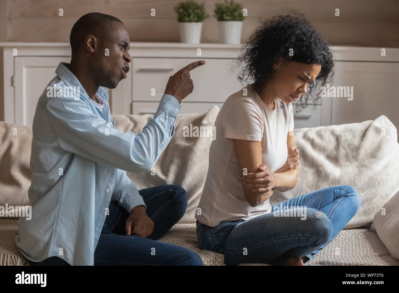 Mad african American man scold blame offended wife Stock Photo