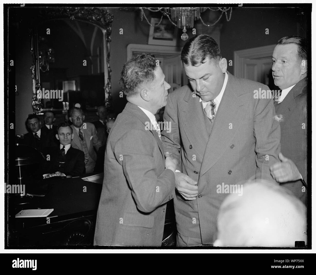 Last minute huddle. Washington, D.C., March 28. Senator Allen J. Ellender (left) whispers into the ear of Governor Richard W. Lesche of Louisiana today just before the Governor [...] before the Senate Commerce Subcommittee to urge passage of the Overton Amendment for construction of the Organza Flood Way in southern Louisiana. Gov. Lesche told the committee the people of his state [...] Unanimous urging the passage of the bill [...], he urged, would be of great aid to Louisians in averting Mississippi River floods, 3/28/38 Stock Photo