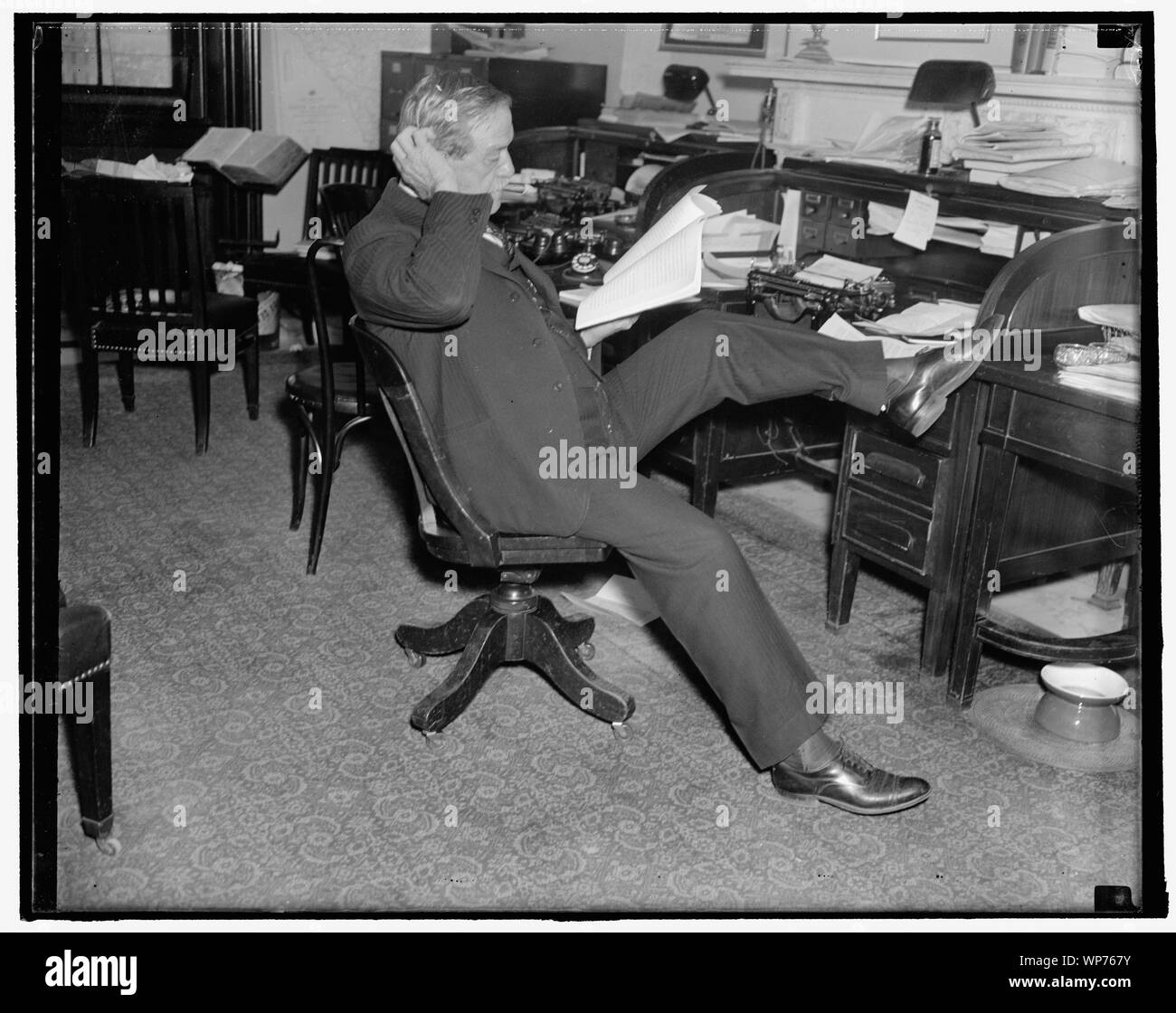 Last study of farm bill. Washington, D.C. Senator Ellison D. Cotton Ed Smith, Chairman of the Senate Agriculture Committee, makes a last- minute study of the newly drafted Farm Bill before introducing it on the floor of the Senate today. 11/22/37 Stock Photo