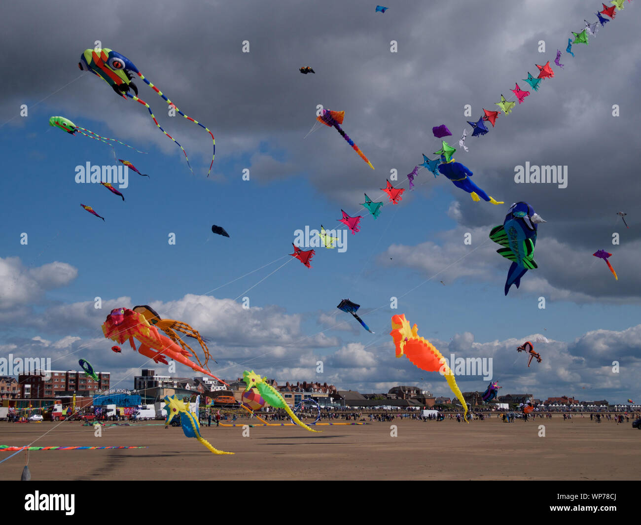 Sunshine and a good strong wind bring colour to the skies at the St. Annes International Kite Festival in Lancashire, England. Stock Photo