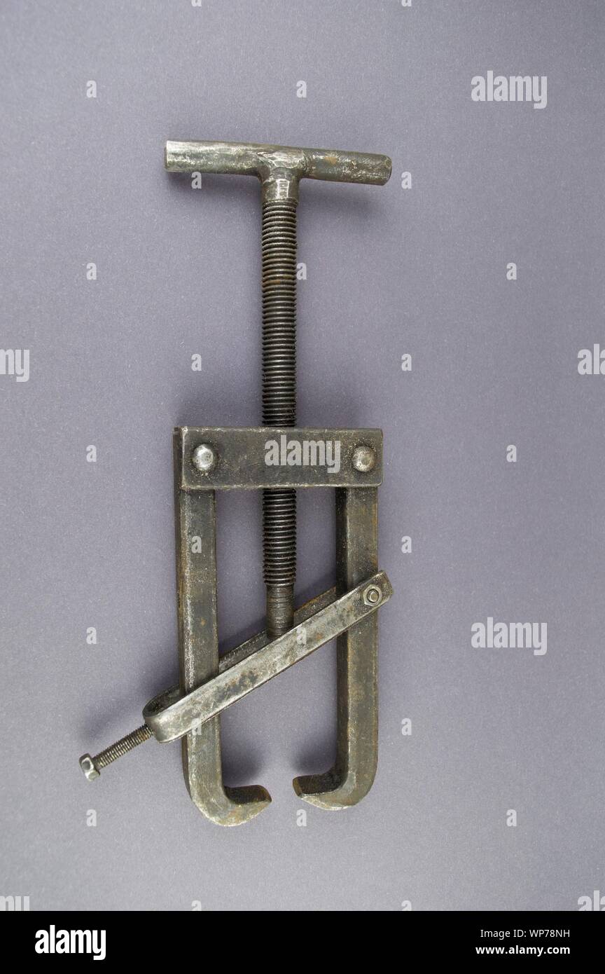 Metal bearing puller on a gray background with empty place for text. Stock Photo