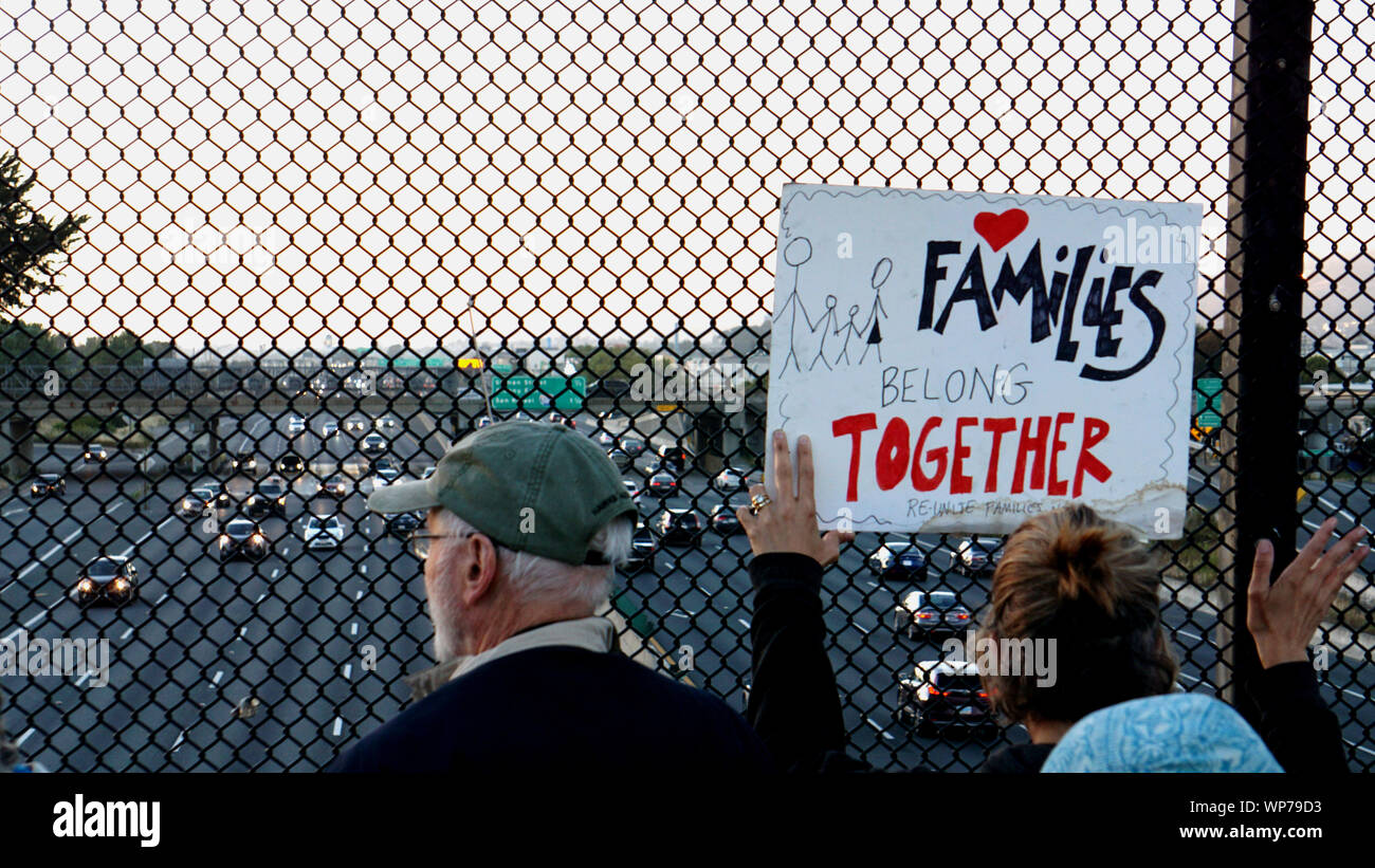 Lights For Liberty vigil to protest US camps at the border.  Protestors on Berkeley Pedestrian Bridge over Highway 80. Families Belong Together sign. Stock Photo