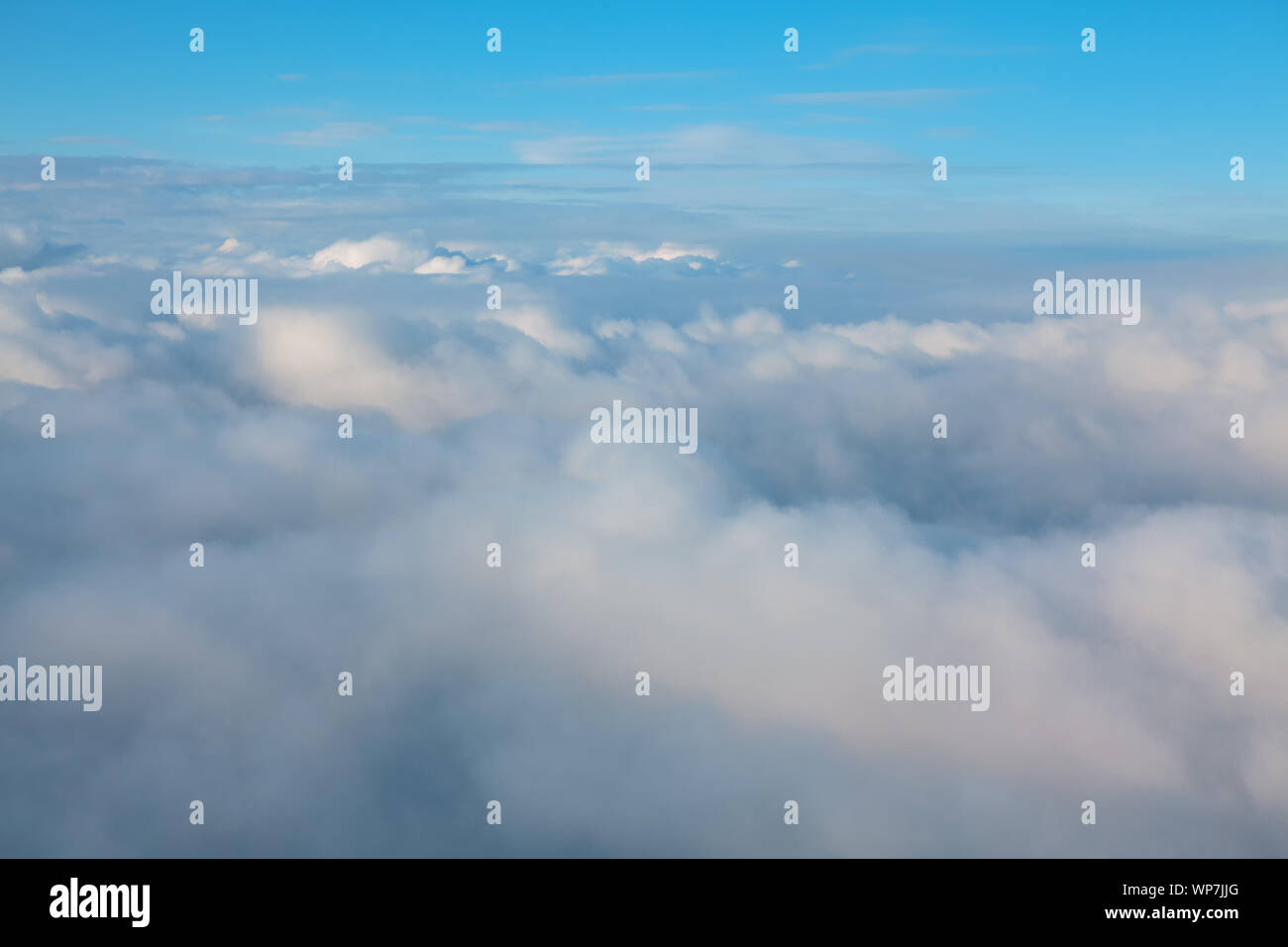 view of the of the cumulus clouds from the airplane window Stock Photo ...