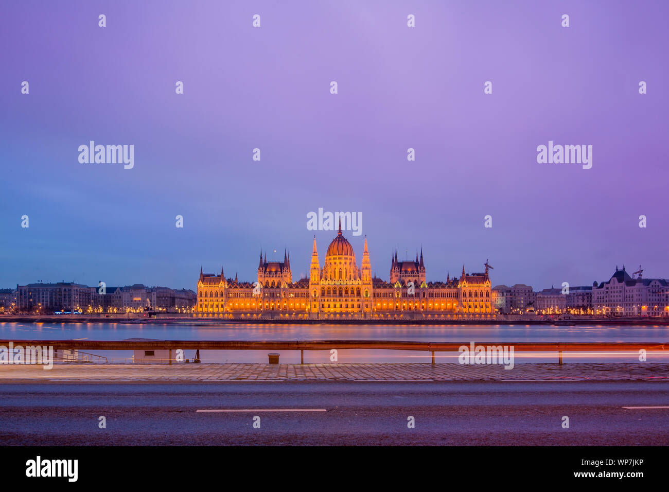 Cityscape of Budapest with colorful parliament and Danube river. Pink and purple colors of sky