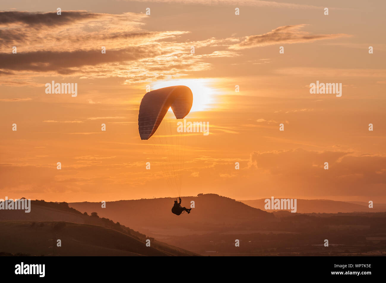 Devils Dyke, Brighton, Sussex, UK..7th September 2019. Paraglider pilot flying on the Northerly  wind over  the beautiful South Downs as mist moves in. . Stock Photo
