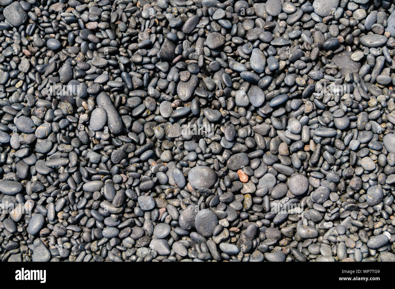 Background of smooth rounded stones on the beach, Maui, Hawaii, USA Stock Photo