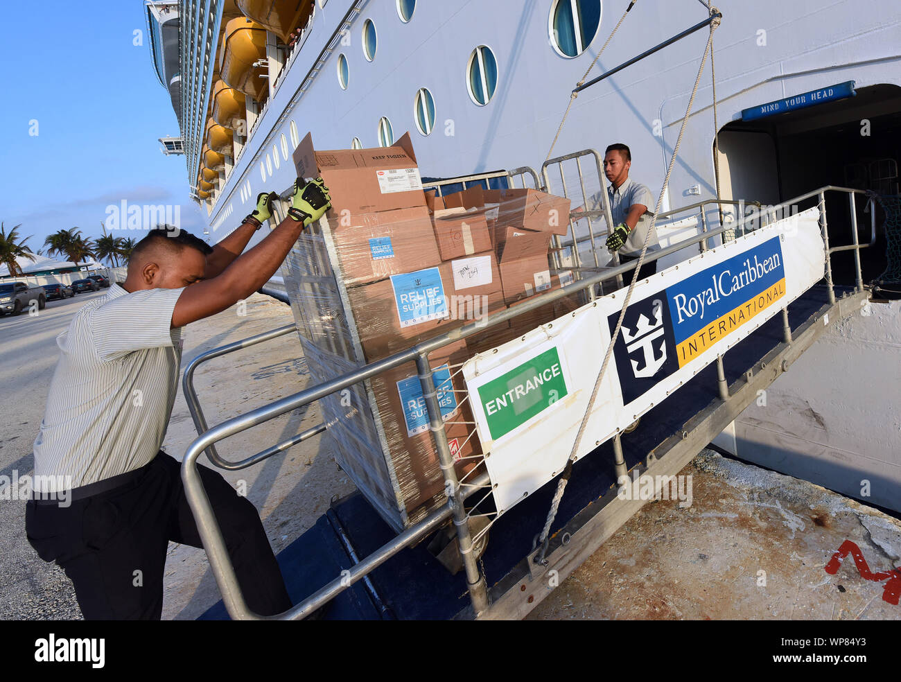 Freeport, The Bahamas. 07th Sep, 2019. September 7, 2019 - Freeport, Grand Bahama, Bahamas - Royal Caribbean International employees aboard the cruise ship Mariner of the Seas unload 20,000 meals for the victims of Hurricane Dorian on September 7, 2019 after arriving in Freeport, Grand Bahama. Hurricane Dorian hit the island chain as a category 5 storm, battering them for two days before moving north. Credit: Paul Hennessy/Alamy Live News Stock Photo