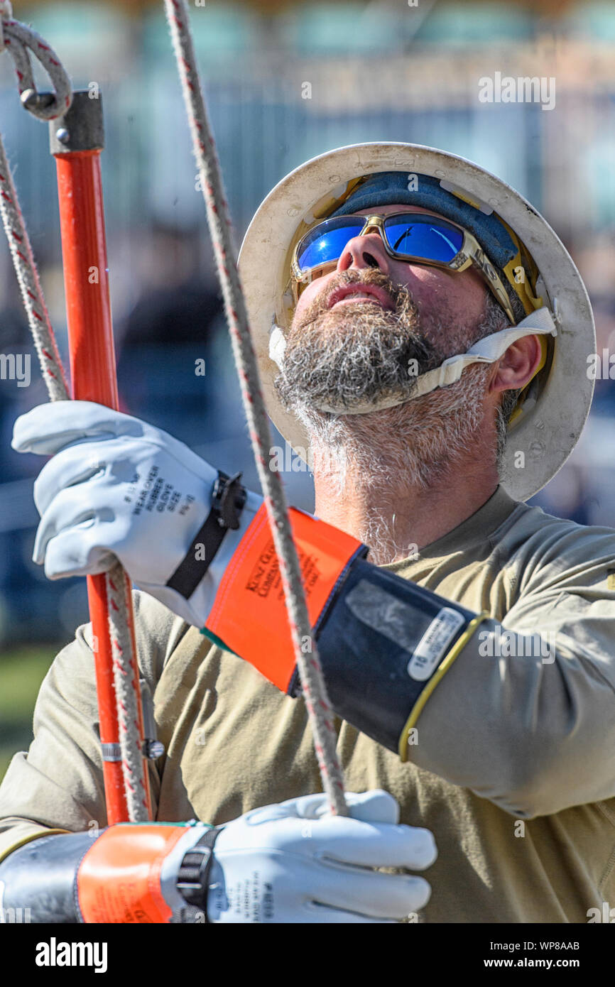 Construction worker at a job site holding a pole Stock Photo