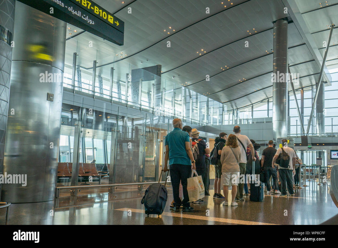 DOHA QATAR JULY 13 2019; Passengers waiting in line with baggage