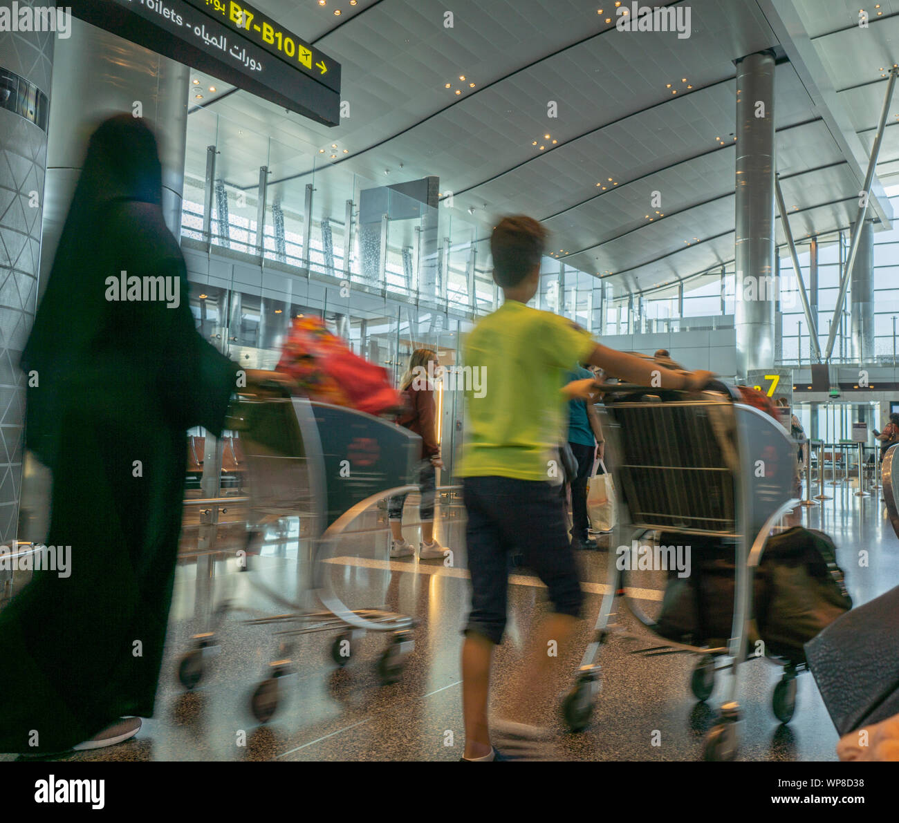 DOHA QATAR JULY 13 2019; Passengers waiting in line with baggage