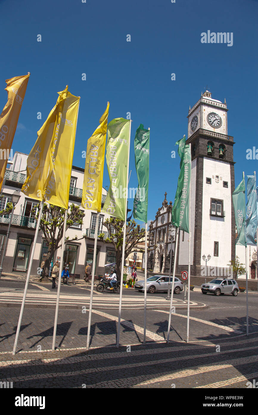 View of Sao Sebastiao church tower in the downtown of Ponta Delgada and flags with the names of the villages in the municipality. Azores, Portugal. Stock Photo