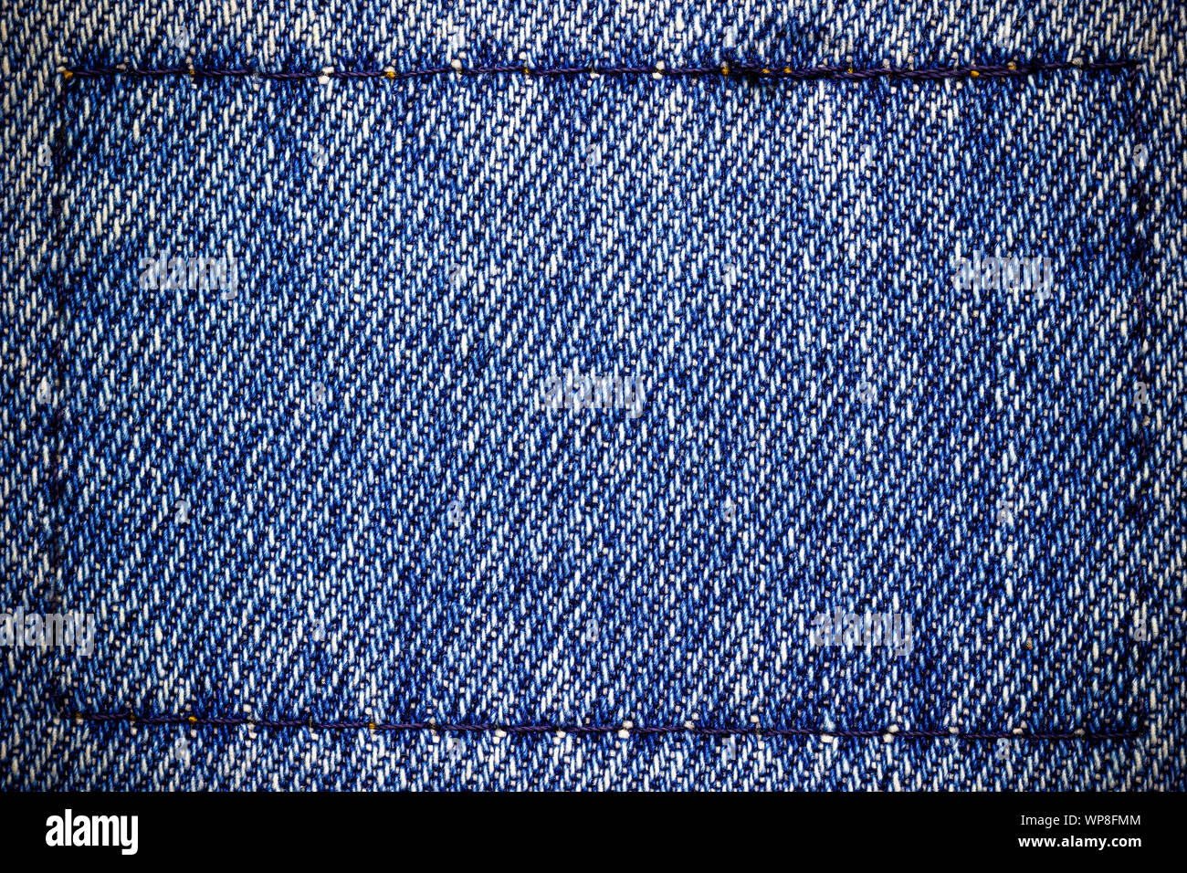 Frame or border of jeans fabric stitch. Concept of vintage clothes or fashion. Stock Photo
