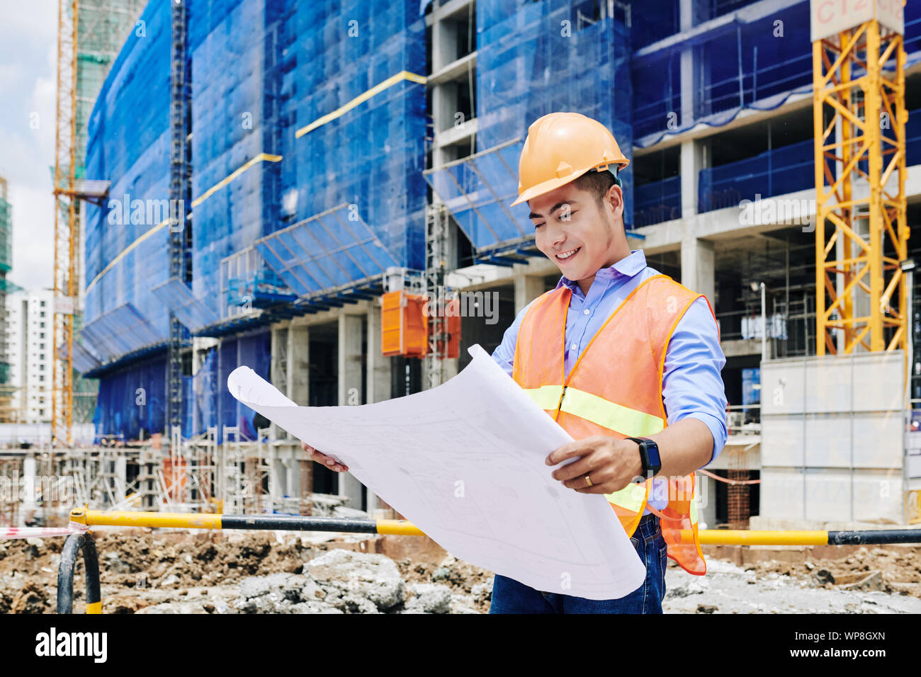 Construction worker examining concrete hi-res stock photography and ...