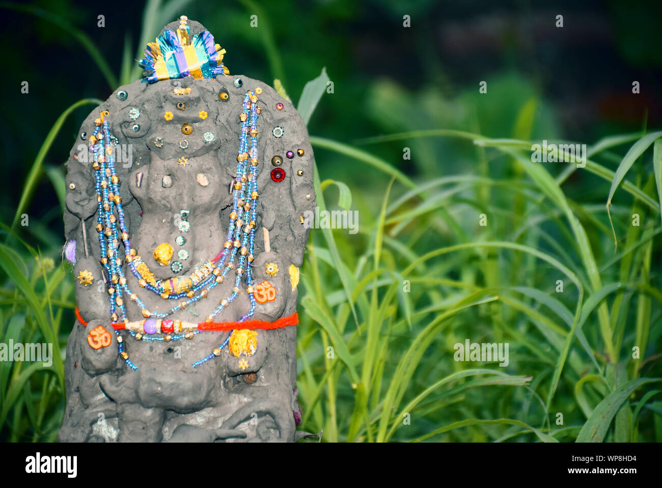 Lord Ganesha in selective focus, made of clay with background, in indian village Stock Photo