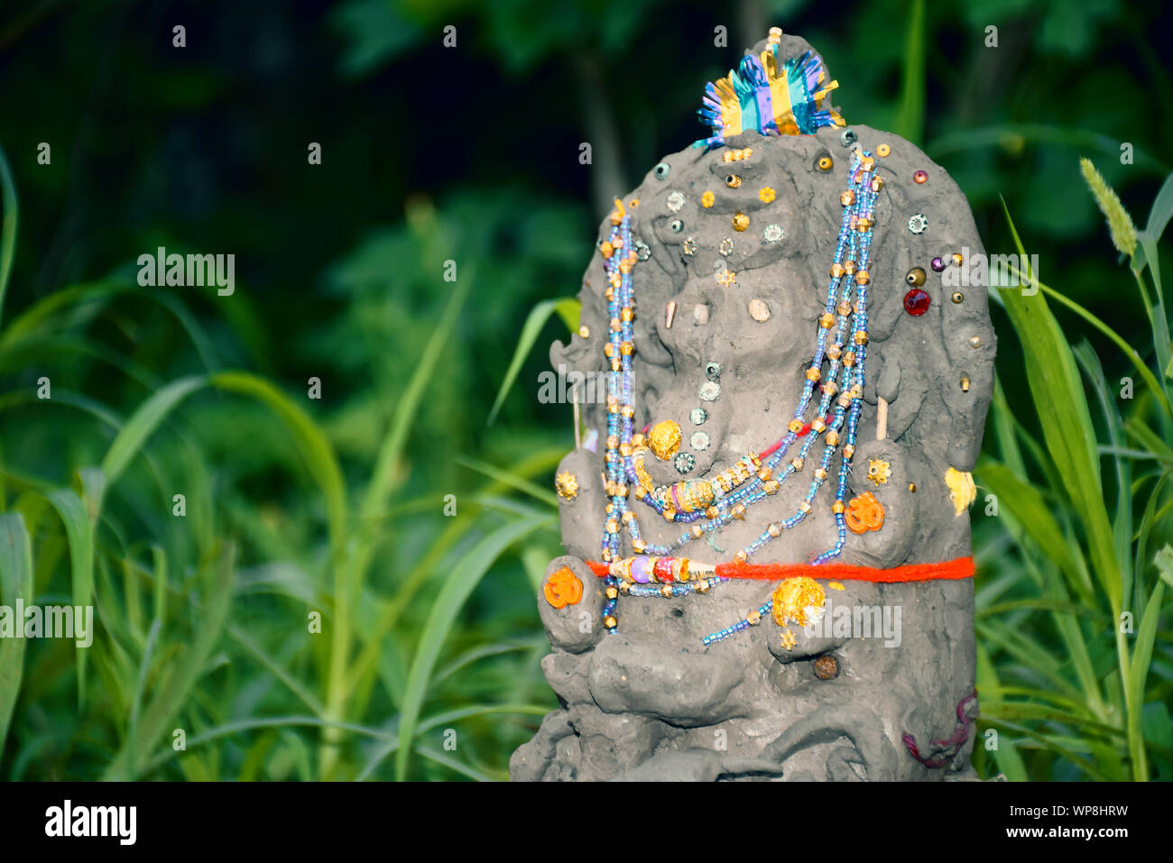Lord Ganesha in selective focus, made of clay with background, in indian village Stock Photo