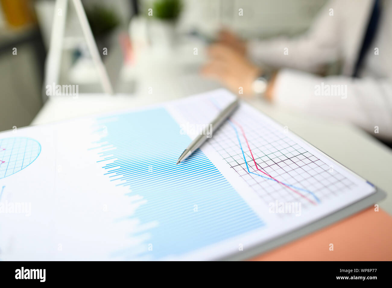 Silver pen lies on paper documents with color Stock Photo