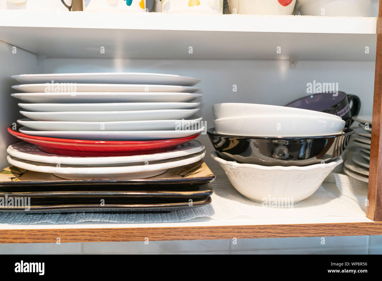 Stack of Plates in Kitchen cupborad at home Stock Photo Alamy