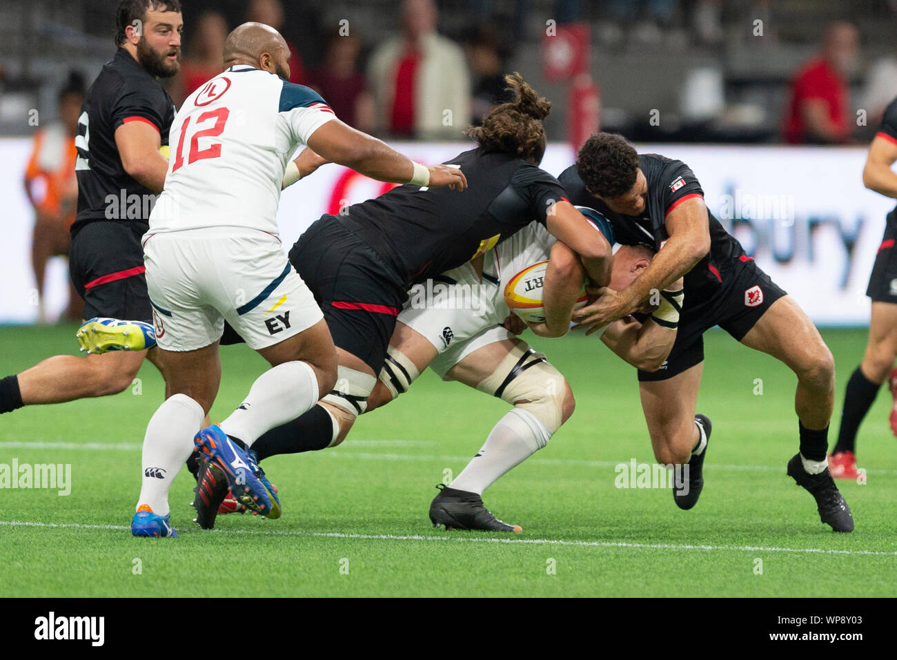 Vancouver, Canada. 7 September, 2019.  U.S.A. Hanco Germishuys (7)(white), being tackled by Canada Lucas Rumball (7)(left) and Canada Ciaran Hearn (12)(right). USA wins 25-15. World Cup Rugby pre-game - Canada vs USA, at BC Place Stadium, Vancouver, Canada. Gerry Rousseau/Alamy Live News Stock Photo