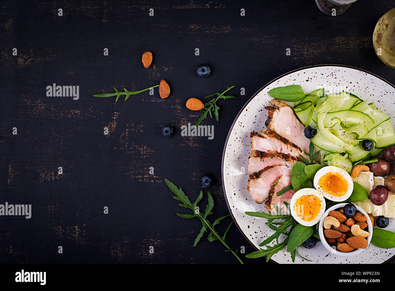 Ketogenic diet. Keto brunch. Boiled egg, pork steak and olives