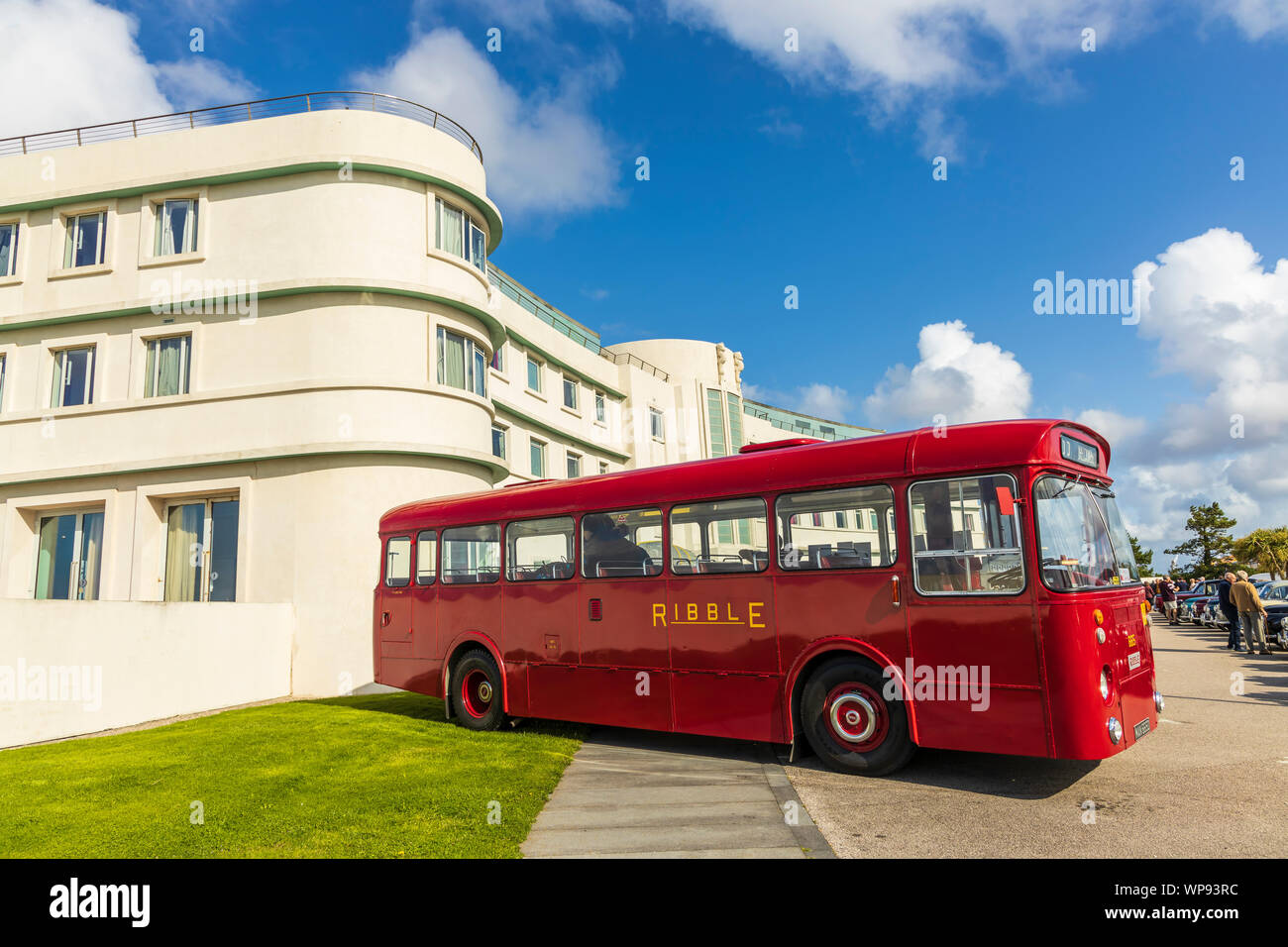 Historic Art Deco building of The Midland Hotel in Morecambe, England with retro red bus at the grounds during the Vintage By The Sea festival. Stock Photo