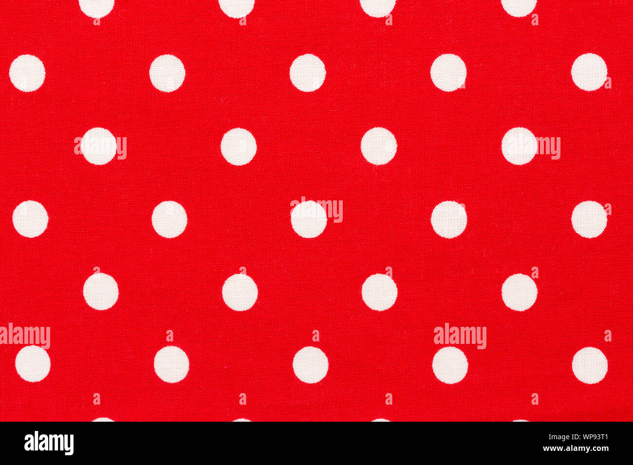 Red background with white polka dots pattern. Stock Photo
