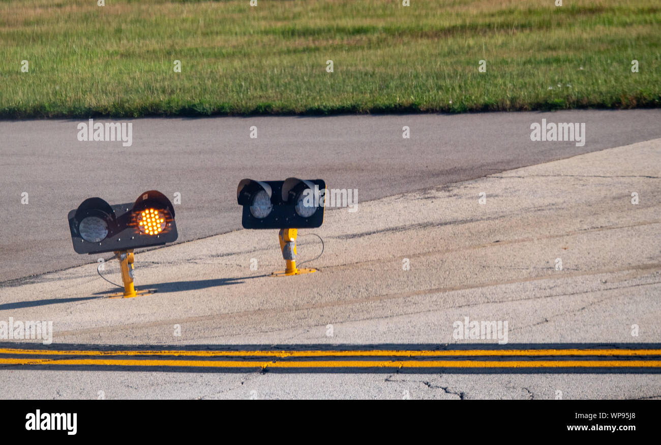 Airport runway traffic lights on yellow caution in the daytime Stock Photo