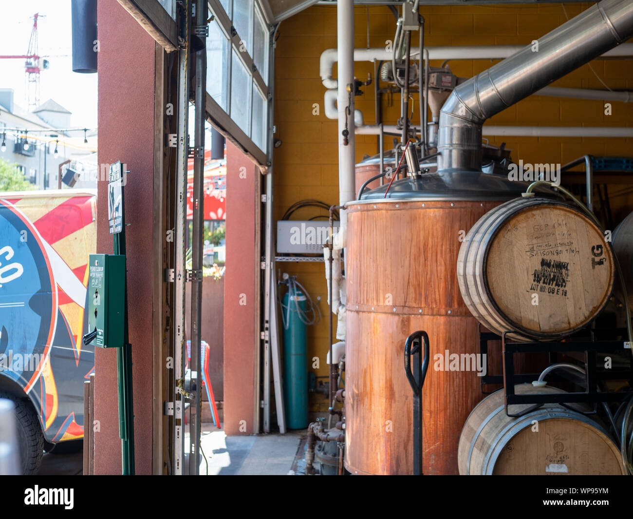 Various tanks, barrels, and beer making equipment at brewery Stock Photo