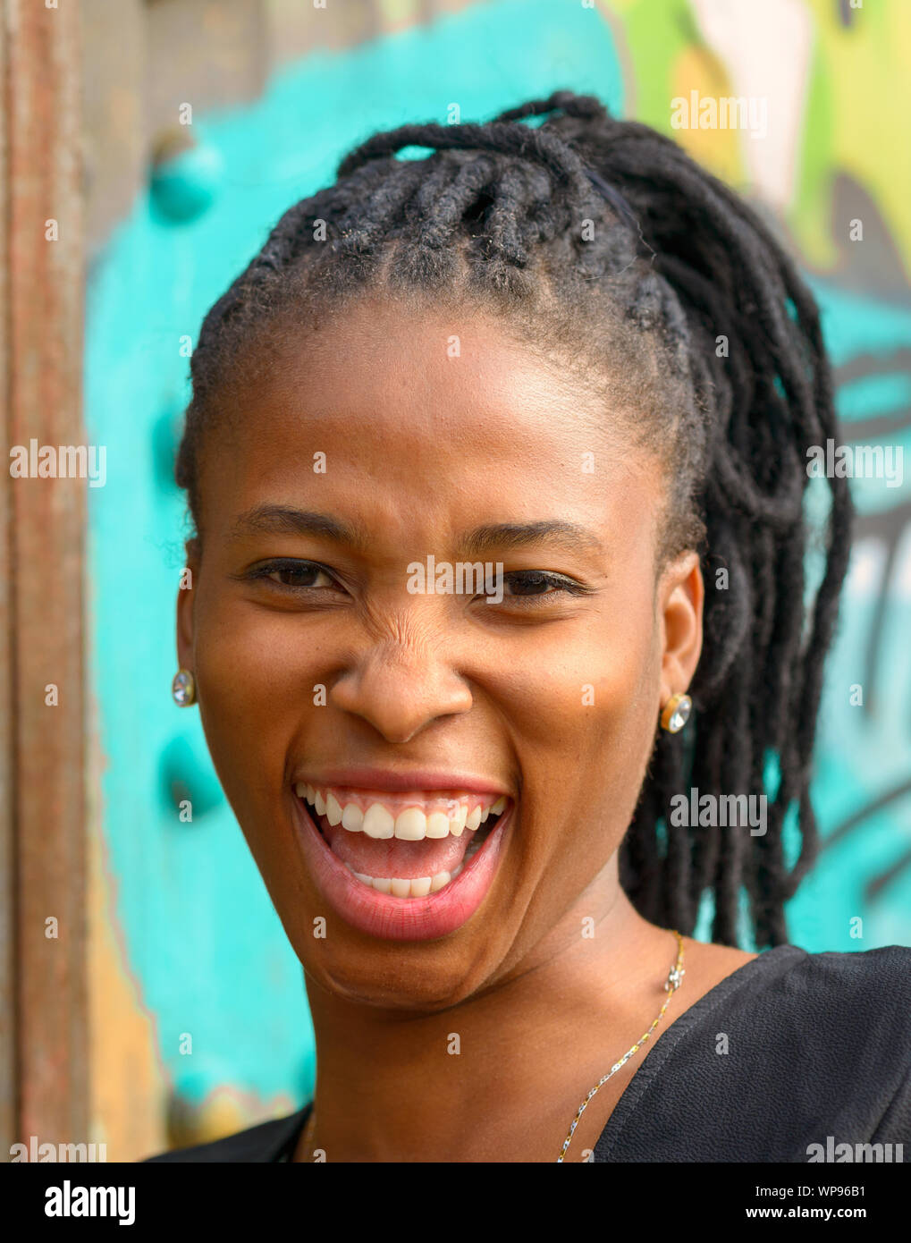 Portrait of an attractive young African woman with a vivacious smile ...