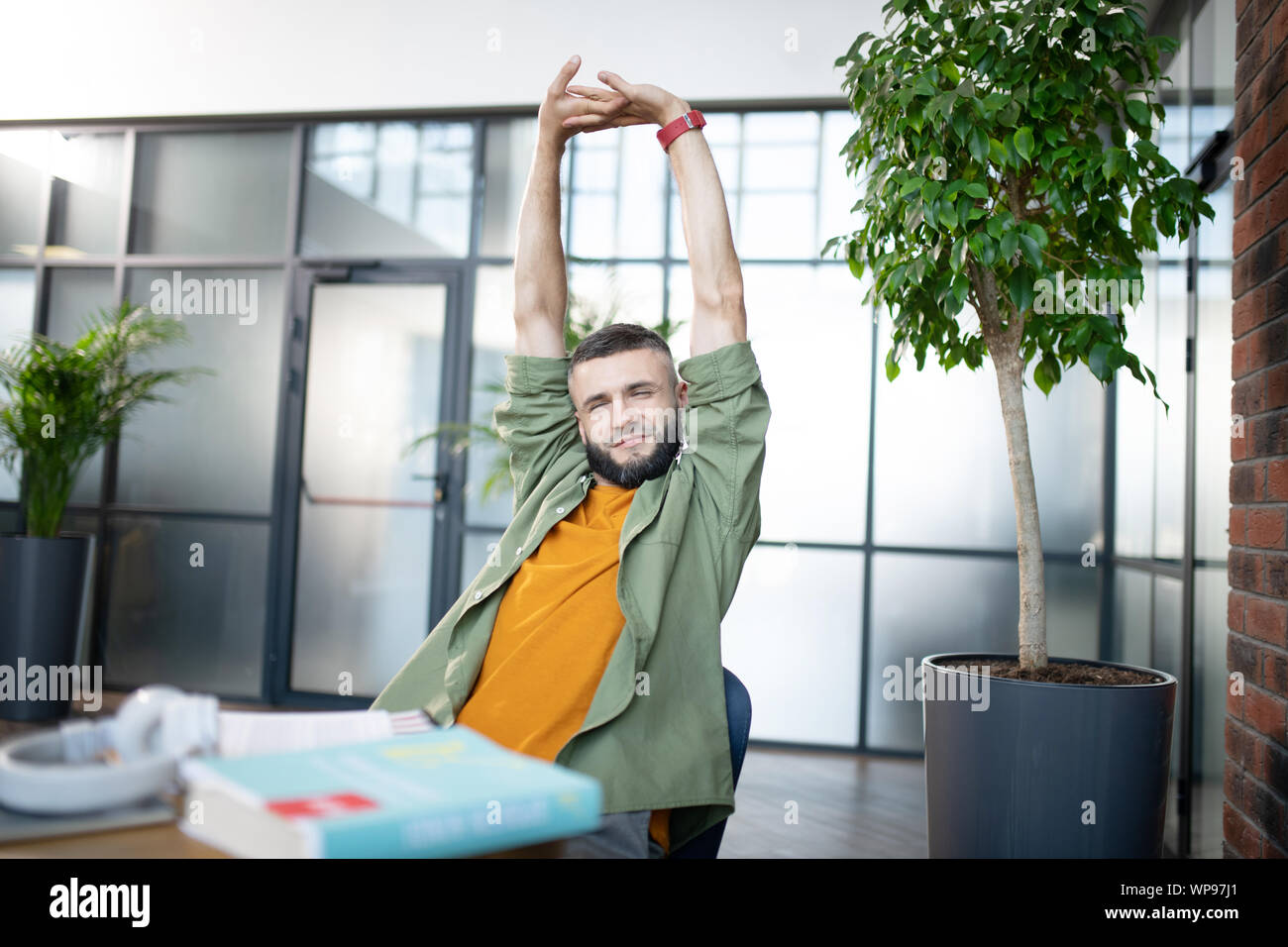 Bearded man feeling sleepy and tired after learning Stock Photo