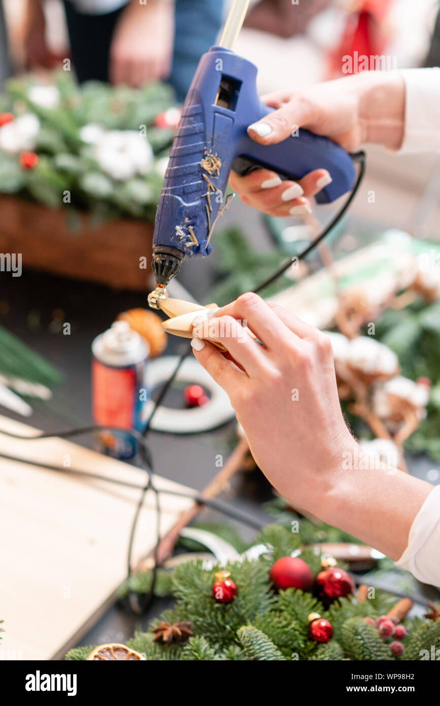 Woman make floral decor with melt glue gun Stock Photo - Alamy