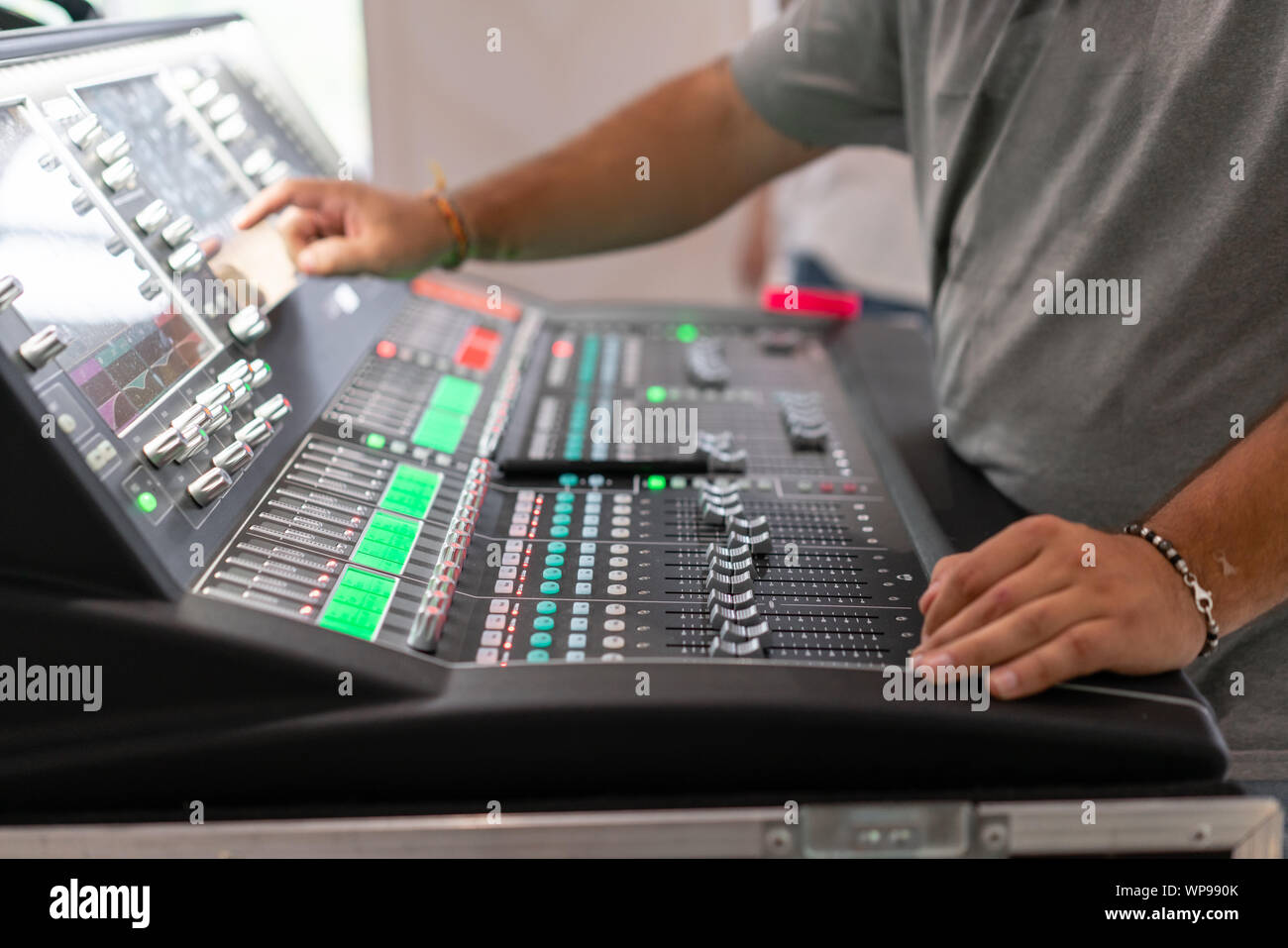 Male Hand On Control Fader On Console Sound Recording Studio