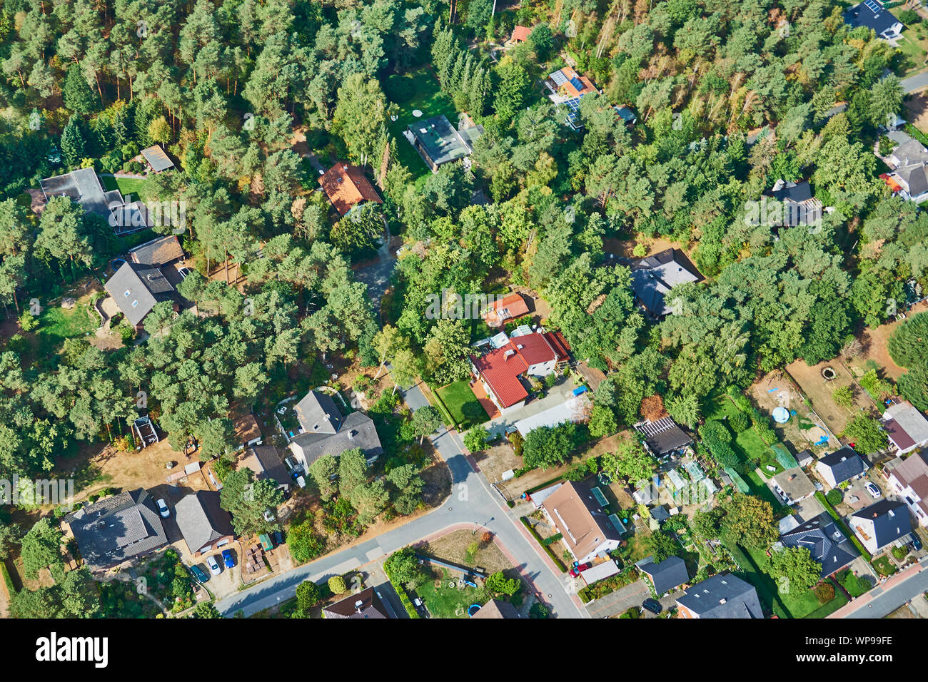 Gifhorn, Germany, September 16., 2018: Forest area sprawled by single-family houses near a large city, aerial view Stock Photo