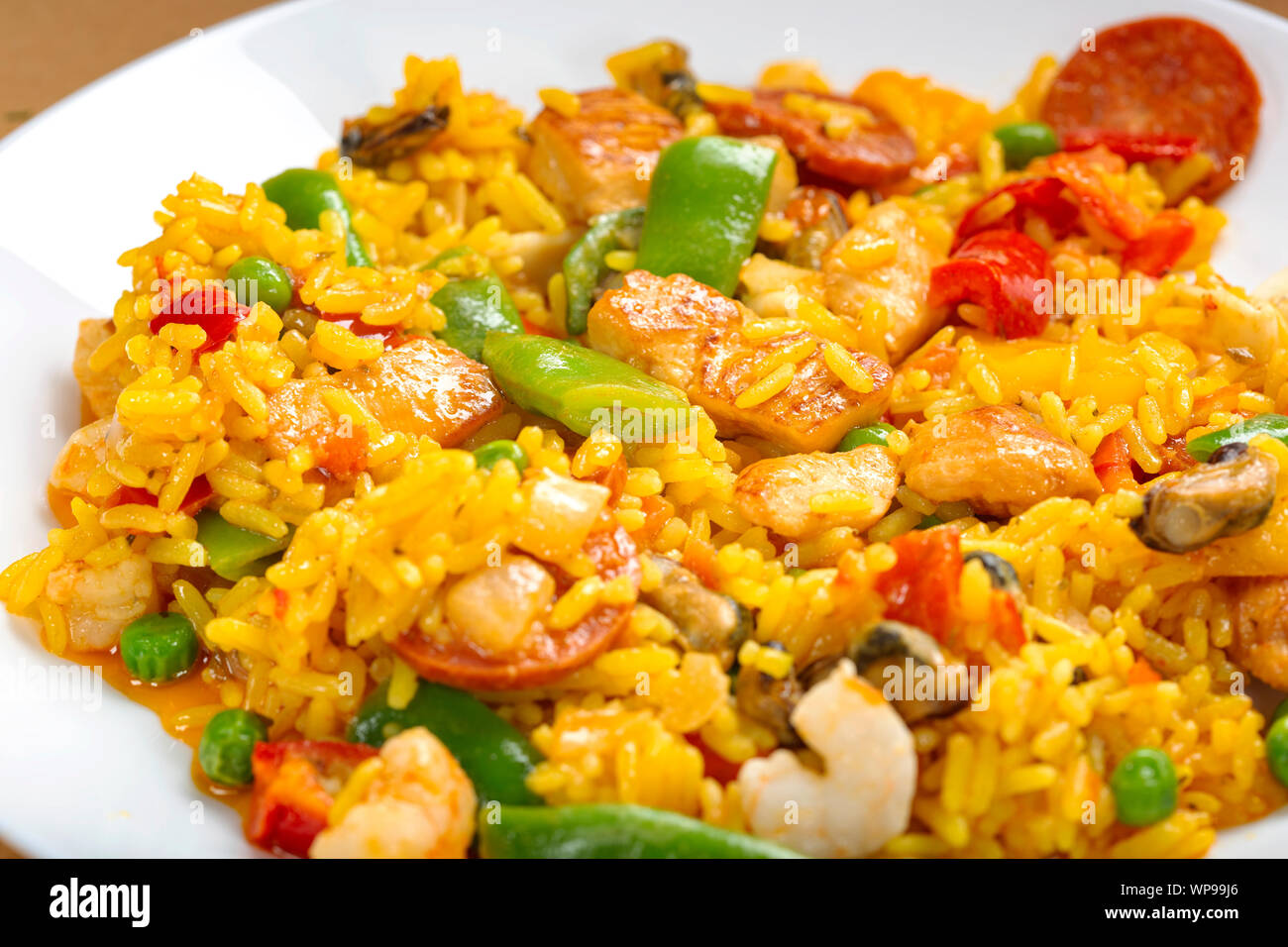 Traditional Spanish paella with seafood and chicken on a white plate Stock Photo