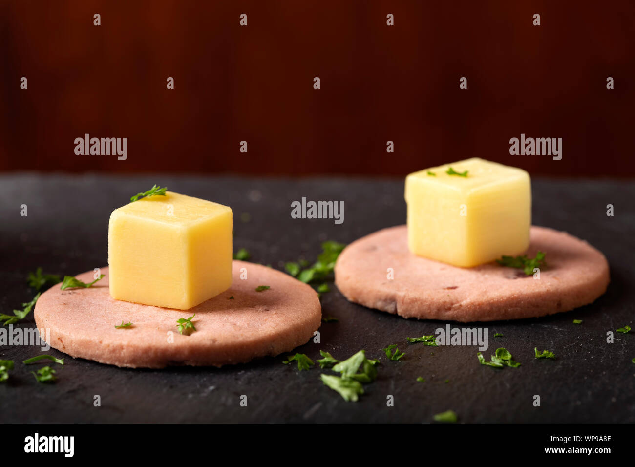 Finger food - raspberry biscuit with cheese and chopped parsley - top view Stock Photo