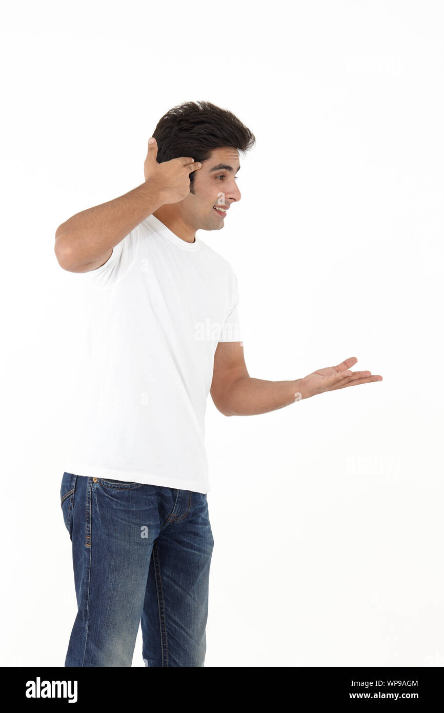 Young man pointing gun head hires stock photography and images Alamy