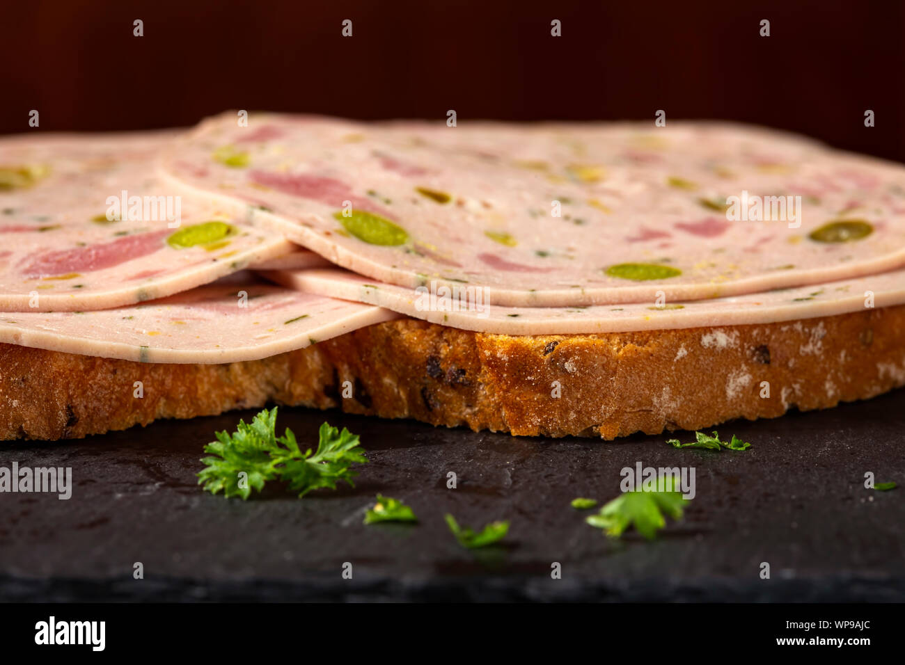 Open sandwich with Salami made from green vegetables like olives and pepper - close up view Stock Photo