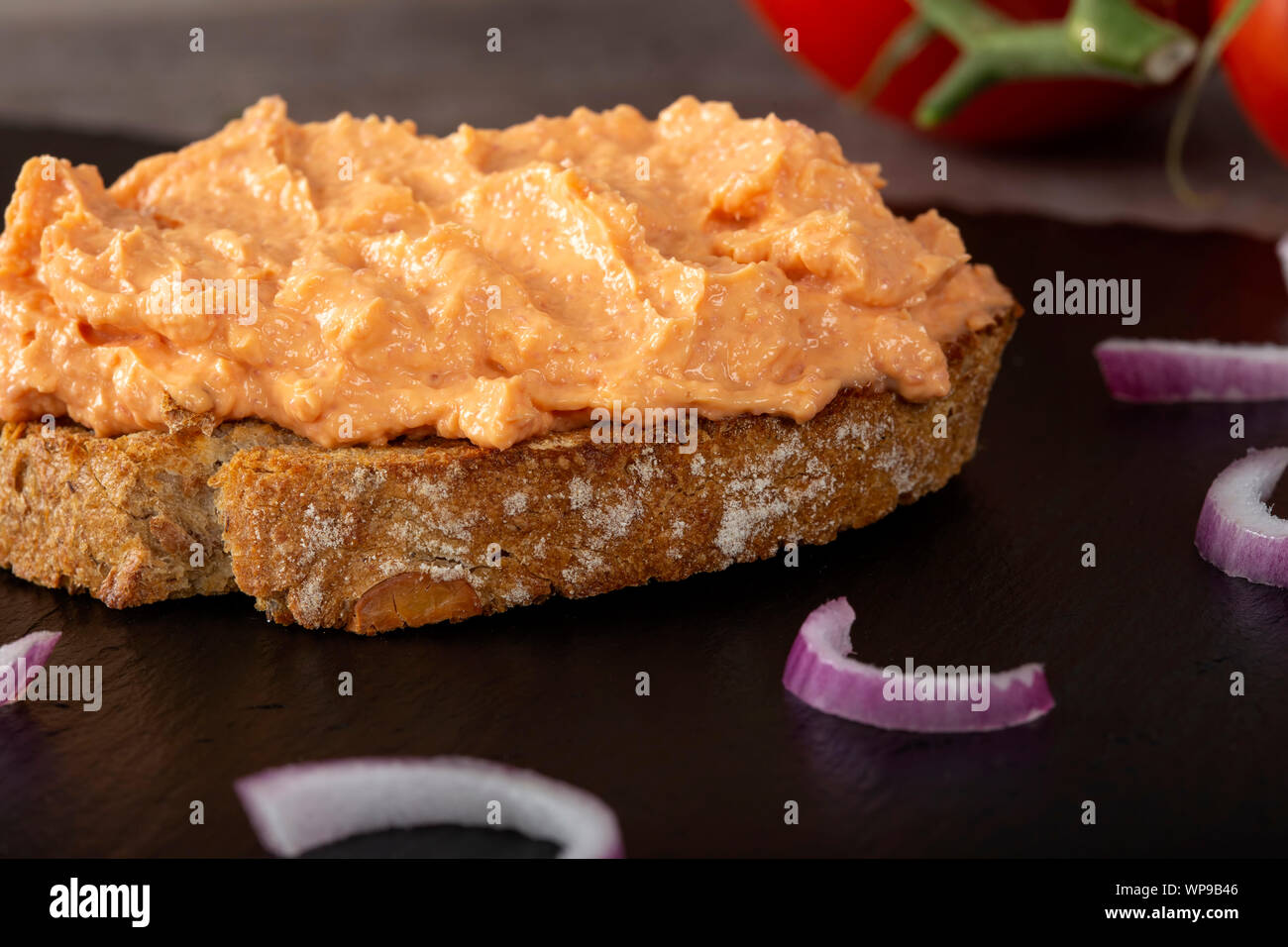 Spread on a toast bread with chopped purple onion - close up view Stock Photo
