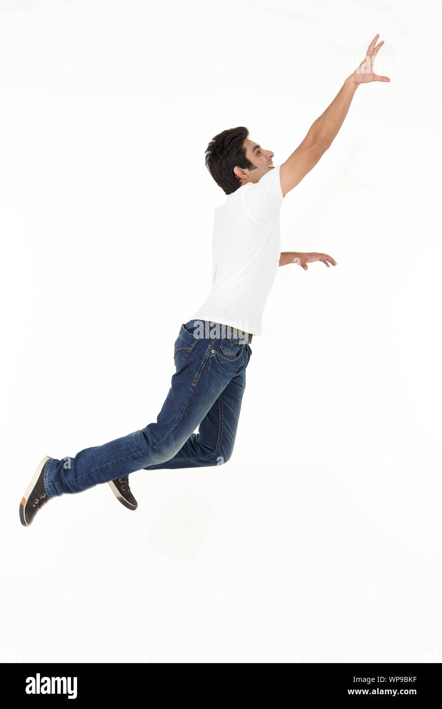 Young man reaching in air Stock Photo Alamy