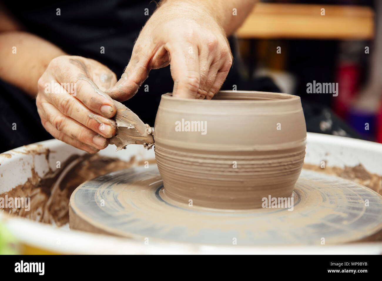 Close up detail view at an mail artist makes clay pottery on a spin