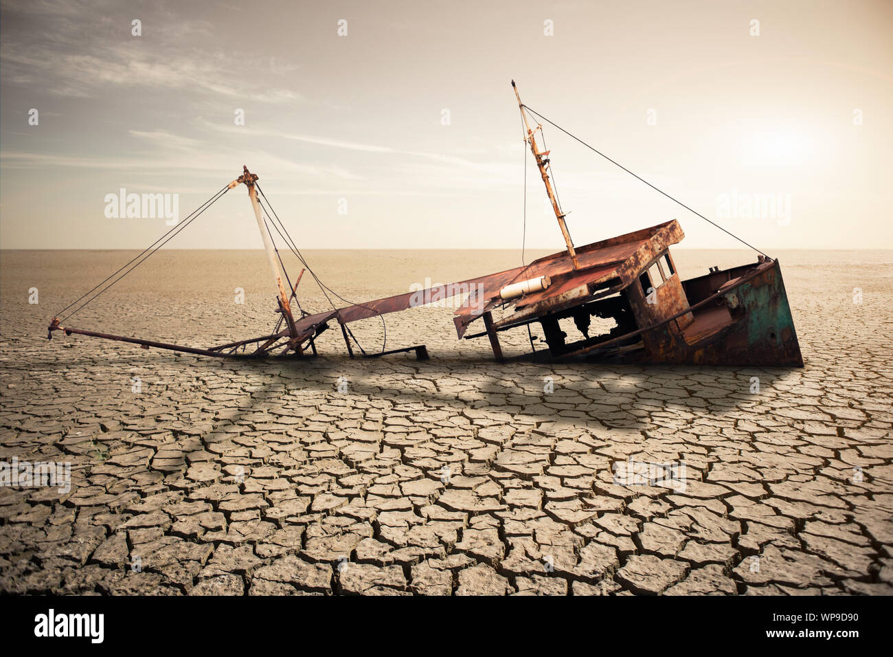 Rusty ship in a dried ocean. Concept of global warming and climate change Stock Photo