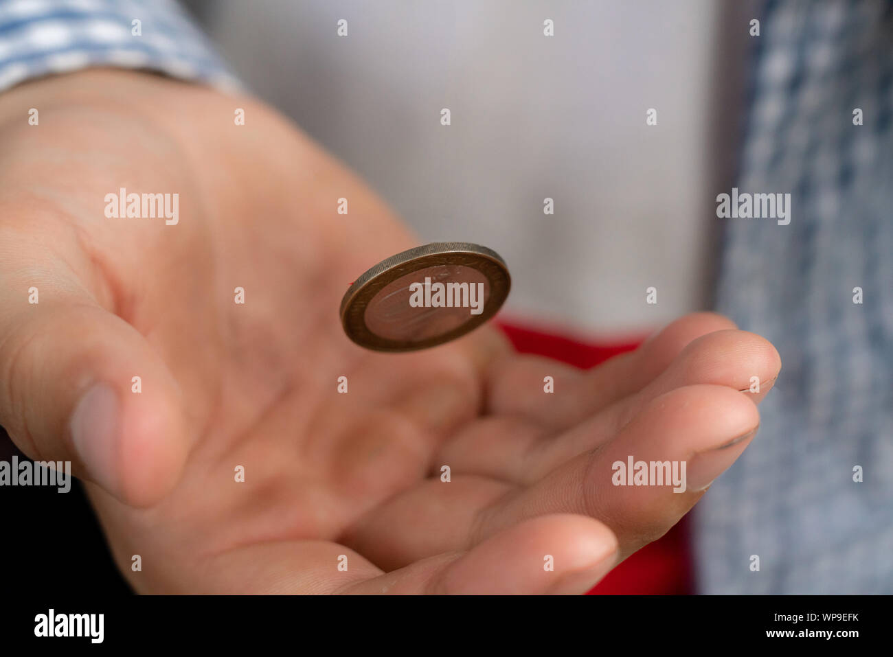 close up shot of hand toss a coin, probable and winning chances concept, fiftyfifty s Stock
