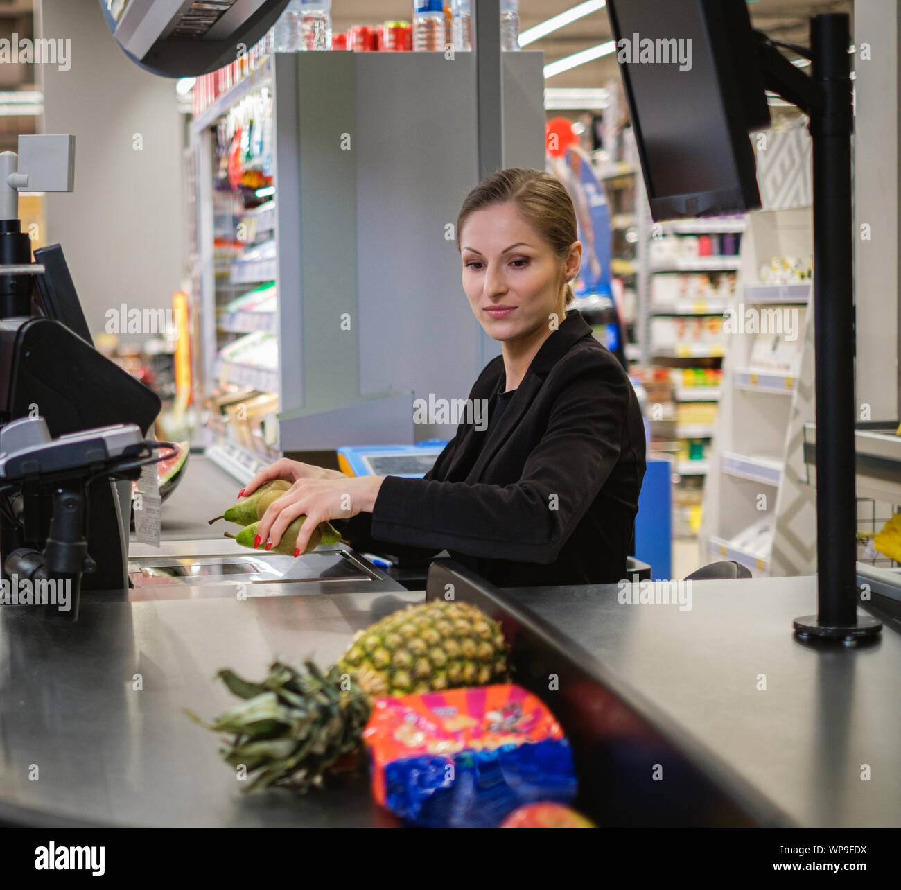 Woman cashier working in a grocery store Stock Photo Alamy