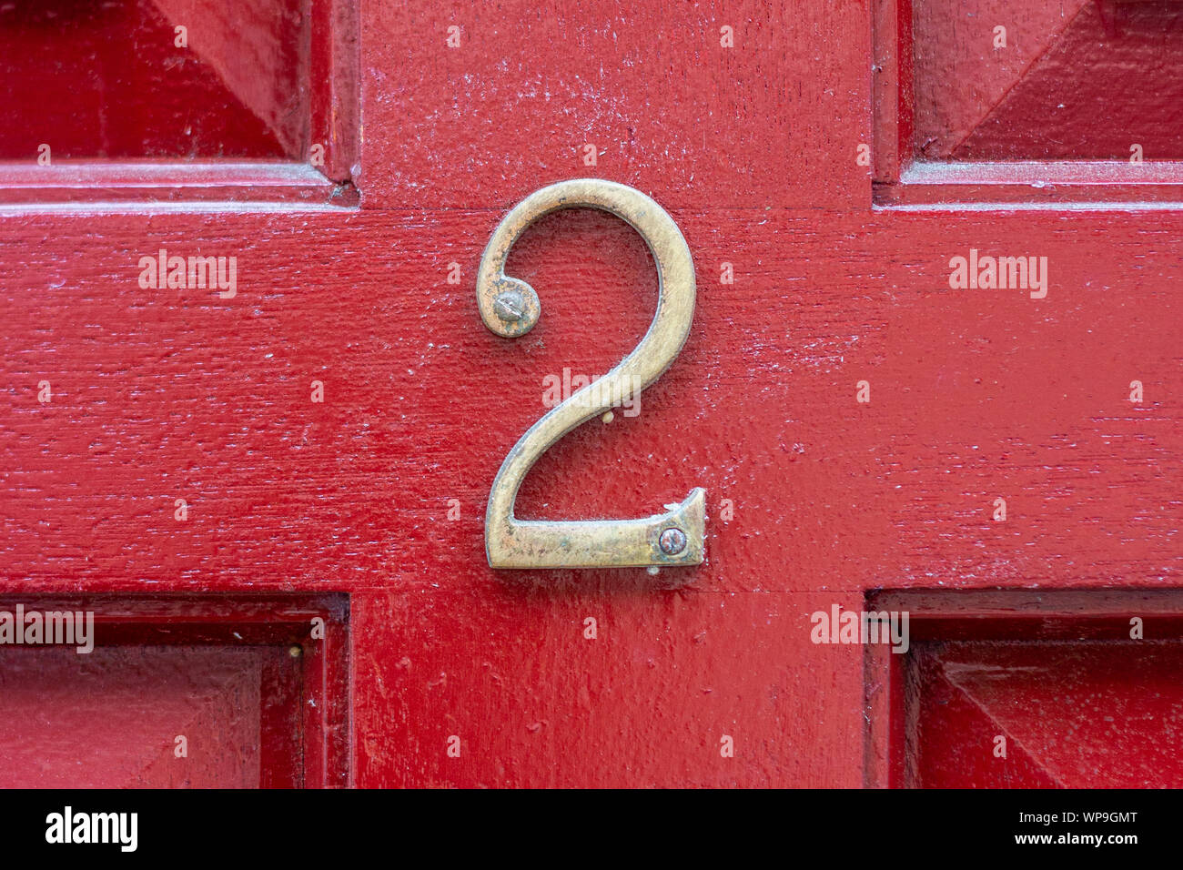 House number 2 on a bright red wooden front door Stock Photo - Alamy