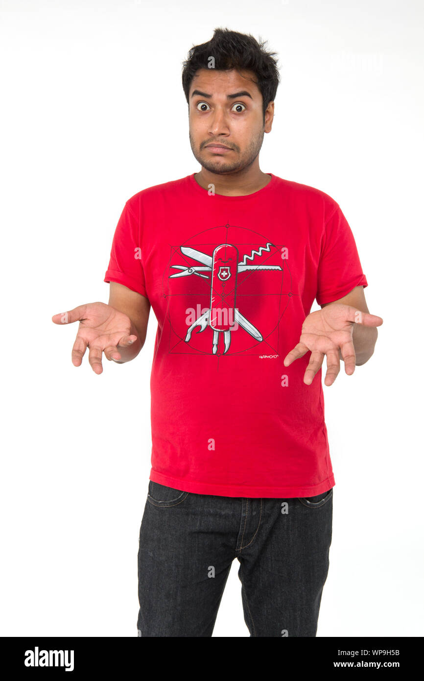 Confused young man shrugging Stock Photo