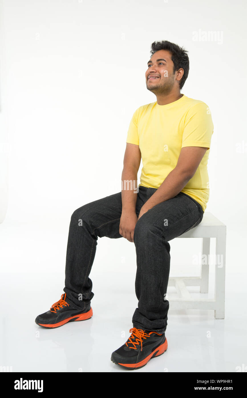 Man sitting on stool hi-res stock photography and images - Alamy